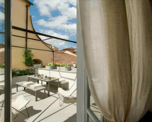 looking out a window at a table on patio