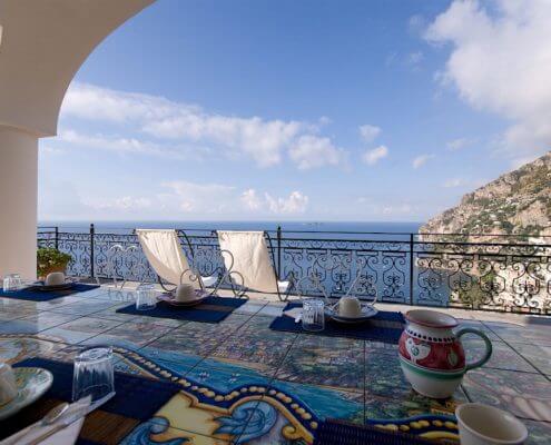 Patio with two chairs looking out over the ocean