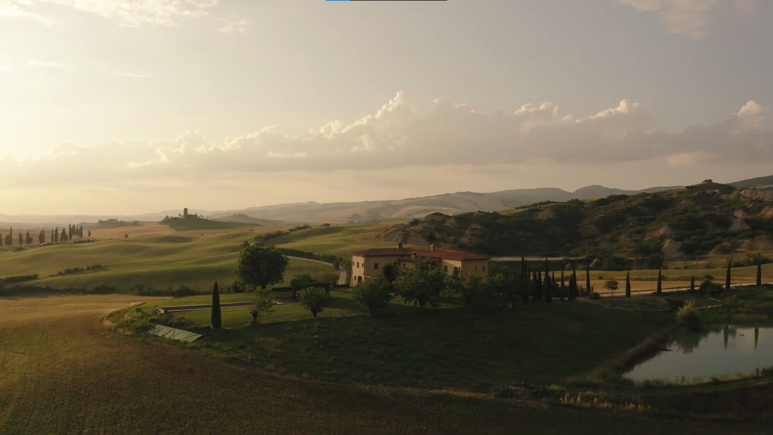 Tuscan villa from above with the hills and landscape stretching out around it.
